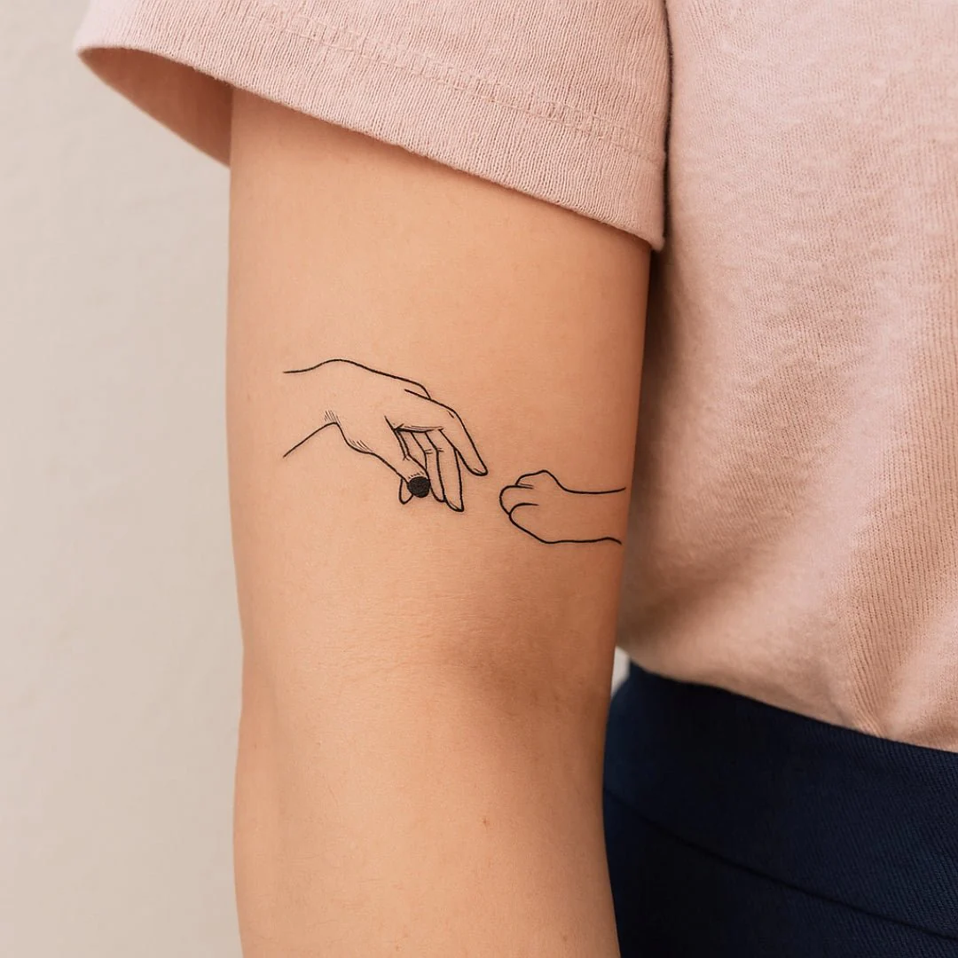 Hand touching cat paw temporary tattoo
